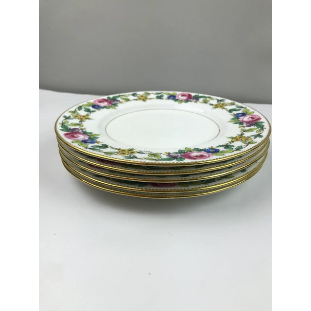 Five highly enameled flower border, each hand signed in script. Plates have 24k gold gilded edge and band around center...