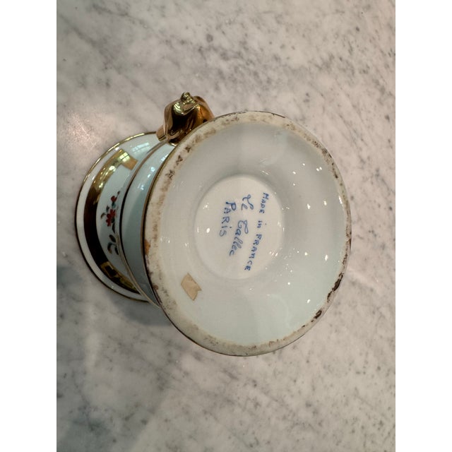 A porcelain Cachepot by Le Tallec exquisitely decorated with hand painted floral bouquets surrounded by richly gilded...