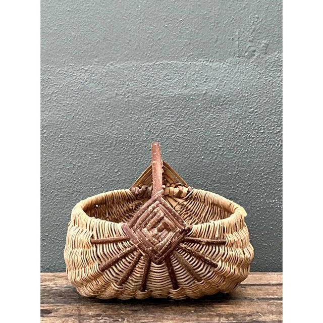 Exhibiting rustic Appalachian and Shaker folk art traditions, this vintage handcrafted egg or melon basket is woven from...