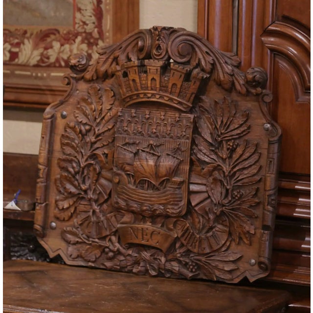Decorate a study, library, office, or paneled hallway with this impressive antique French carved walnut wall plaque....