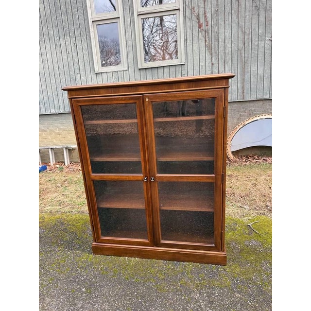 Late 20th Century Traditional-Style Wood 2 Glass Door Bookcase or Display Cabinet Vintage glass front bookcases with three...