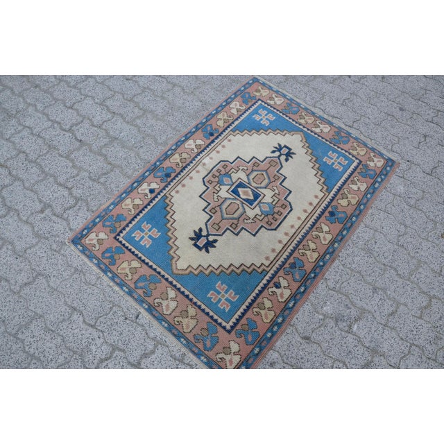 This is a vintage Turkish Oushak rug from the 1960s. The piece was hand-knotted.