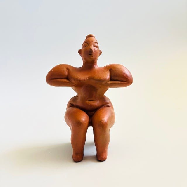A vintage terra cotta pottery figurative sculpture of a seated fertility goddess. Made in Kula, Turkey by replica artist...
