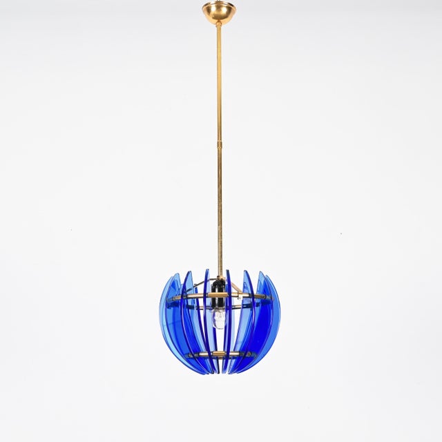 Mid-century italian pendant made in a stunning blue murano artglass and solid brass. This incredibly charming pendant was...