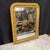 Elegant French Louis-Philippe mirror, distinguished by its classic softly arched crest and substantial giltwood frame. The...
