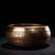 This vintage Tibetan singing bowl is crafted from a bronze alloy, featuring a rich, warm patina with a golden-brown hue....