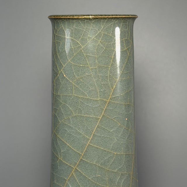Fine antique Chinese celadon long‑neck vase. Elegant slender neck paired with rounded bulbous lower body, covered in...