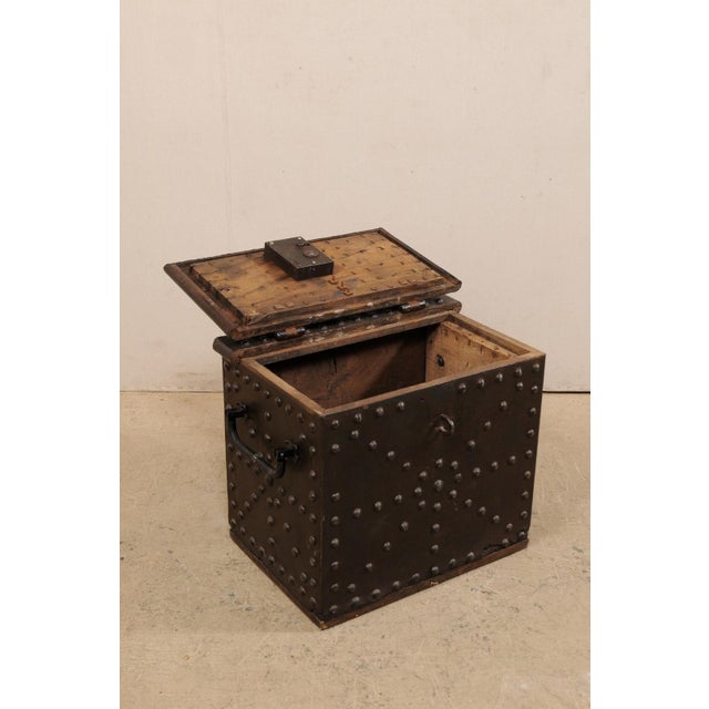 A Spanish strong box from the 18th century. This antique safe from is constructed or iron clad wood, and is handsomely...