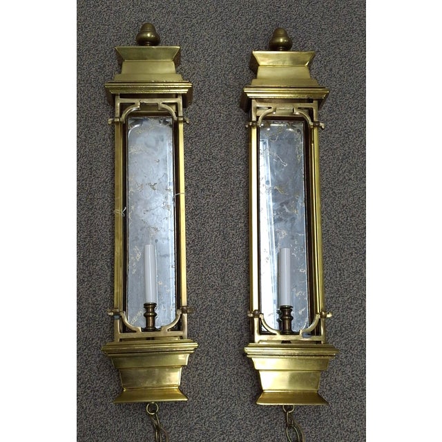 A Pair of French Bronze and Gilt Mirror back Pagoda Form Half Lentern one light Wall Sconces. Measures 6.75" in width and...