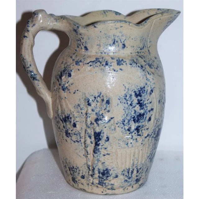 This fantastic rare lady liberty and shield embossed sponge pottery pitcher is in fine as found condition. She is embossed...
