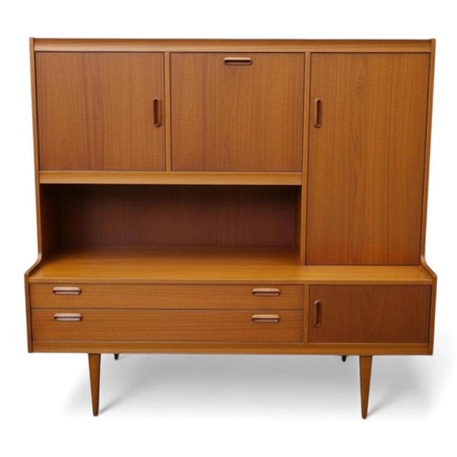 This mid century sideboard by Alfred Cox is a stunning teak highboard designed to elevate your living or dining room...