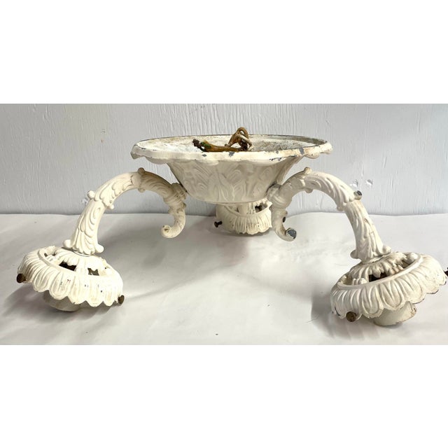Beautiful antique ceiling light fixture with three arms.