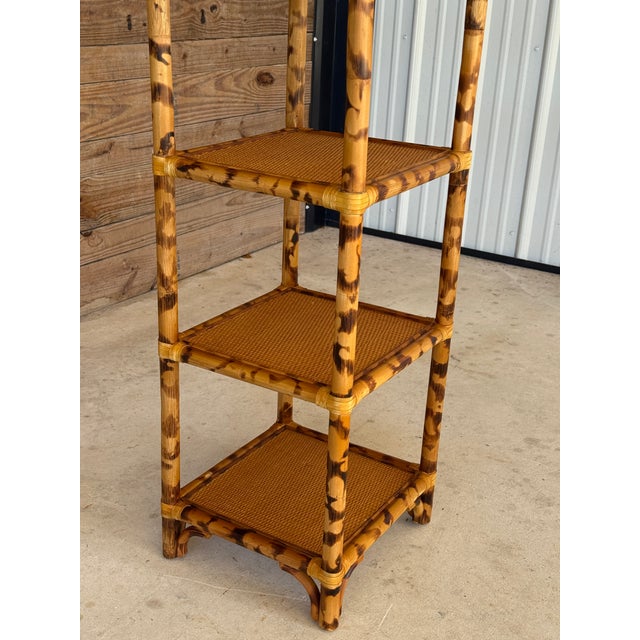 Beautiful vintage tortoise-finished rattan shelving unit, featuring an airy open design with woven rattan shelf surfaces...