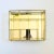 A vintage brass and glass curio display case for hanging on a wall. Rectangular in shape with a variety of compartments...