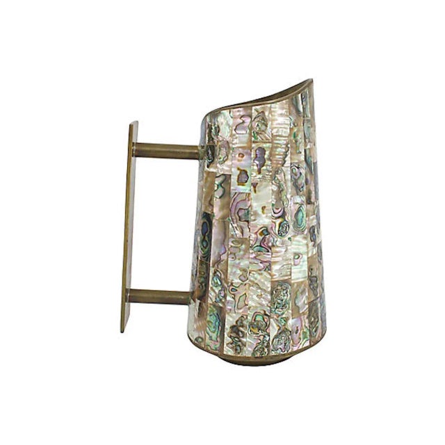 Hand-crafted midcentury brass pitcher with inlaid abalone detail. Marked "Made in Mexico". Minimal tarnish to brass. This...