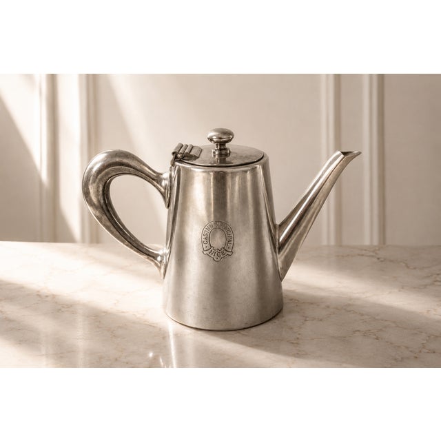 A charming small silver-plated coffee pot produced by the prestigious French silversmith Christofle for the historic...