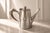 A charming small silver-plated coffee pot produced by the prestigious French silversmith Christofle for the historic...