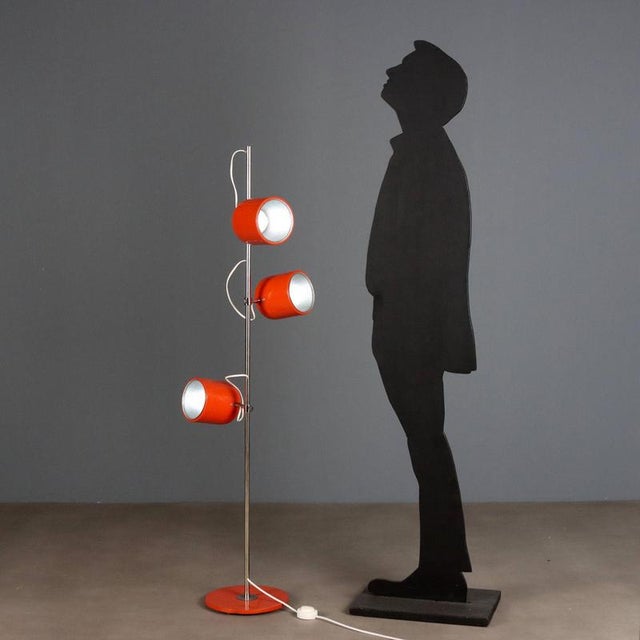 1960s-1970s floor lamp, featuring a functional and lively design. Made of orange enameled metal, it has three adjustable...