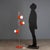 1960s-1970s floor lamp, featuring a functional and lively design. Made of orange enameled metal, it has three adjustable...