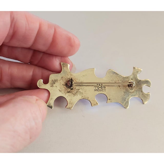 Here's a fun late 20th Century Sterling Silver brooch featuring puzzle pieces. Artisan signed on back 925 TC-316 Mexico....