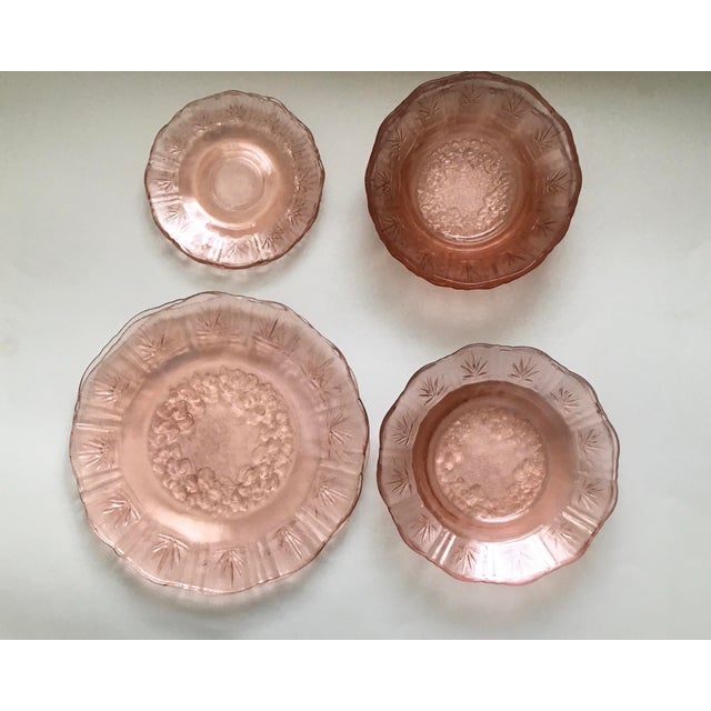 A charming set of pink pressed glass dishes featuring a floral center bordered with lines and leaves. Bowl #1(cereal...
