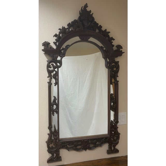 This vintage Indonesian hand carved mirror frame with mirror. Is impeccably caved of mahogany wood, a beautiful mirror on...