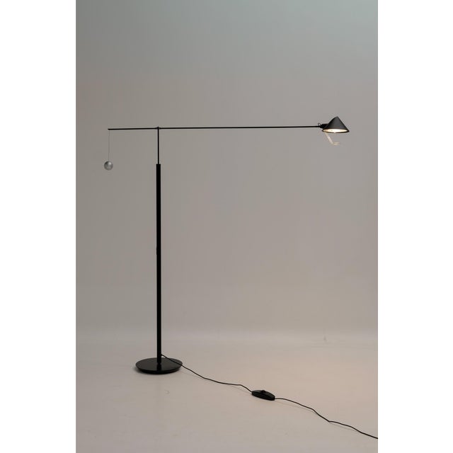 Nestore floor lamp designed by Carlo Forcolini and produced by Artemide. This swing-arm model is made entirely of metal...