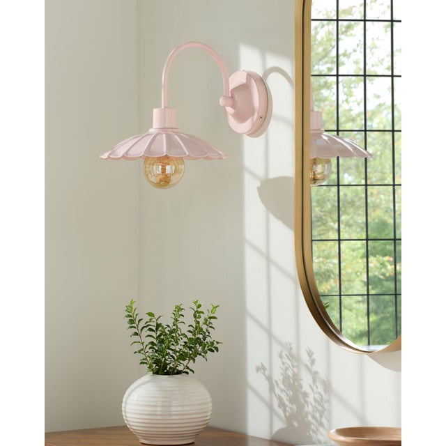 Illuminate your space with the rugged charm of the Pavona wall sconce lighting, where industrial meets rustic in a...