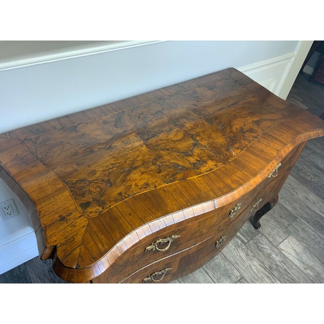 A very attractive late 18th century Italian two drawer serpentine front burl Walnut commode resting on cabriole legs....