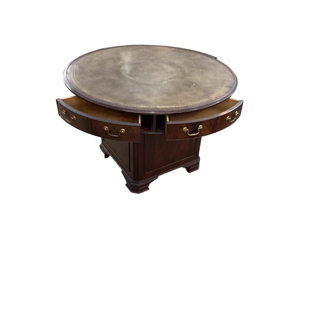 Antique Mahogany Leather Top Rent Drum Table. The to fitted with six wedge shaped drawers. The base has a storage...