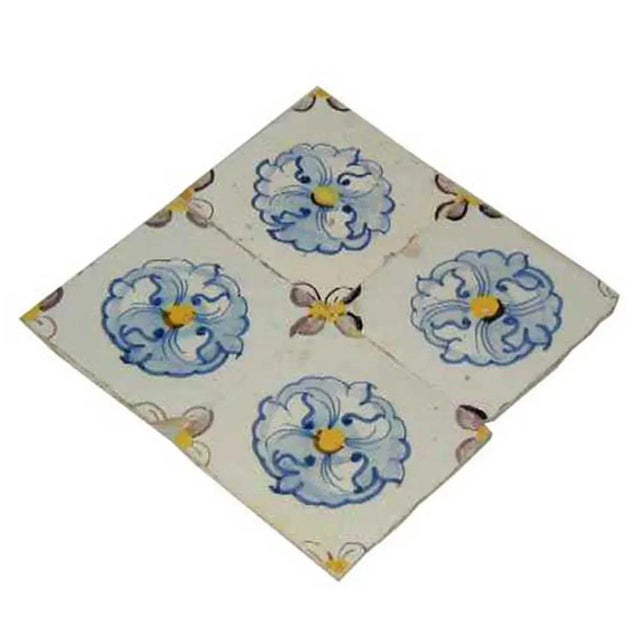 DETAILS An antique, square Azulejo tile with a yellow and blue floral pattern. Azulejos are hand colored, tin-glazed...