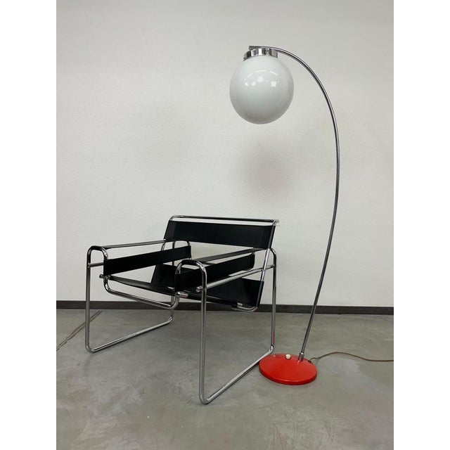 Mid-century modern floor lamp in very good original condition. Red metal base with chrome leg and opaline glass lampshade....