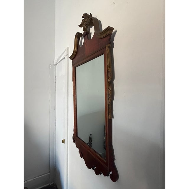Handsome federal style wall mirror circa 1940 featuring a richly figured mahogany frame with satinwood-style inlay, a...