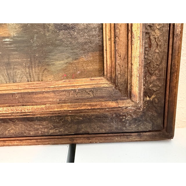 An atmospheric antique European landscape painting attributed to H. Volpini, depicting a tranquil lakeside scene...