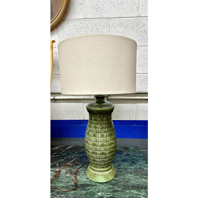 Mid Century Green Ceramic Table Lamp. This MCM ceramic glazed lamp features a circular Geometric pattern. Dimensions with...