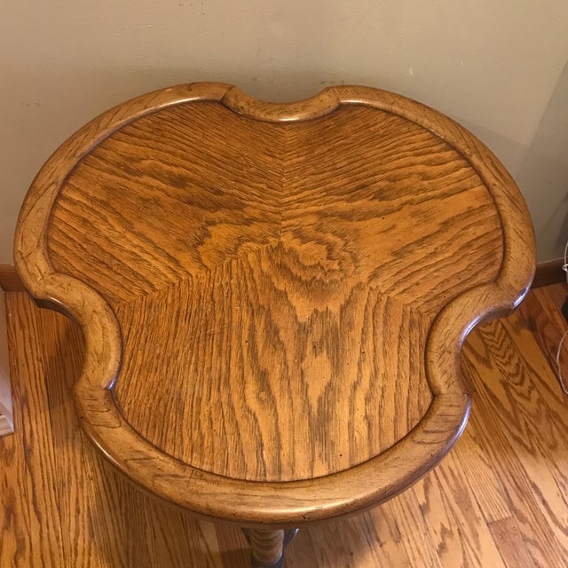 Lovely oak end table, made by Brandt furniture of Maryland. It features a trefoil shaped top, and a triangular lower tier...