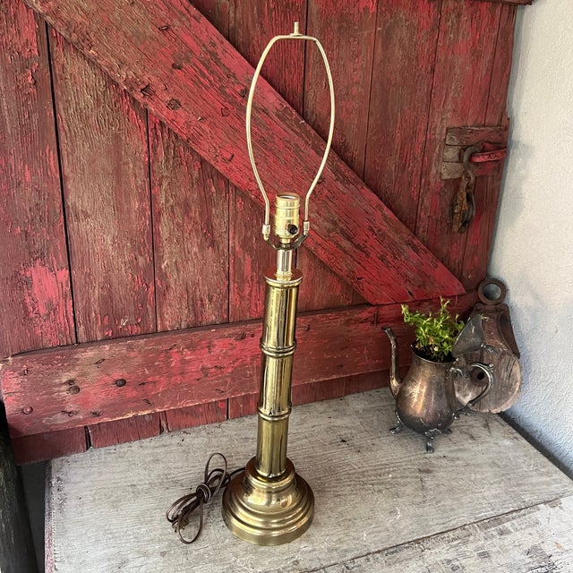 This vintage brass table lamp features a bamboo-inspired design and a warm, golden finish. Its compact 21"x6" size makes...