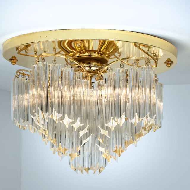 This exceptional flush mount was manufactured by Venini in Italy. The lamp has clear Murano Triedri crystals of varying...