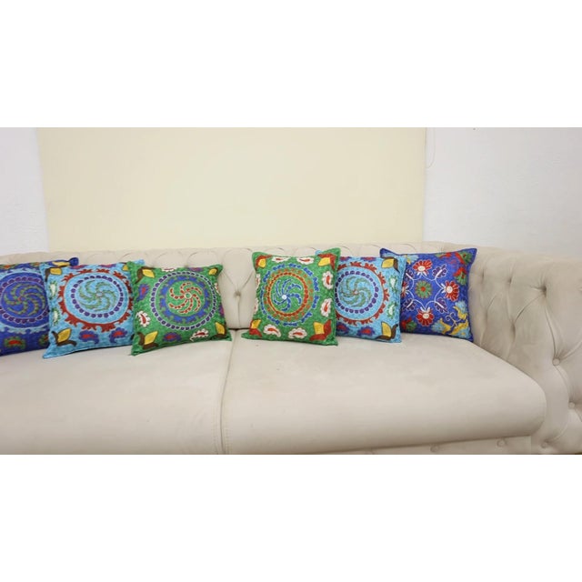 Infuse your home with the rich heritage of Central Asia with this exquisite Hand-Embroidered Suzani Cushion Cover, crafted...