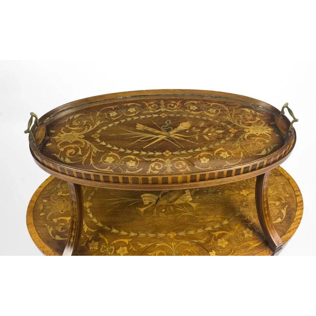 This is a truly exceptional antique English Edwardian mahogany and satinwood marquetry oval two tier 'etagere', in the...