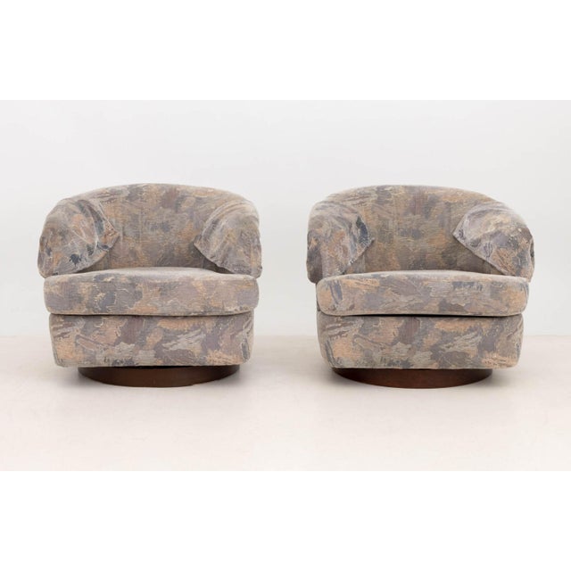Pair of Milo Baughman Style Barrel Swivel Arm Chairs, with purple hue abstract upholstery and matching armrest covers....