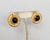 1980s round goldtone cabochon faux-onyx center with "wrapped" design edge with a line of round clear rhinestones at the...