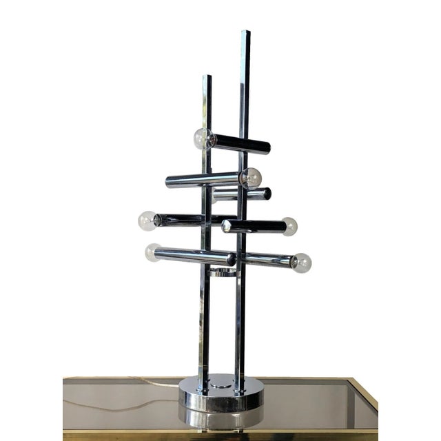 Splendid floor or table lamp in chrome, featuring seven light bulbs placed at the end of chrome intersecting pipes giving...
