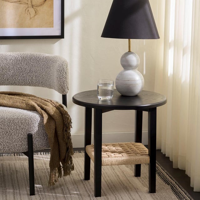 Introducing the Rakoma 1 Shelf End Table where form meets function. This stylish end table combines the bold allure of...