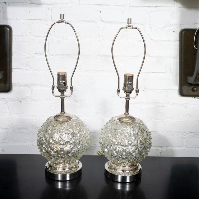 Pair of diamond patterned spherical mercury glass lamps.