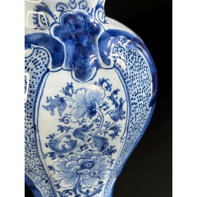 A beautiful example of 18th-century Dutch faience, crafted by the Van Duijn workshop in the Delft style. The vase features...