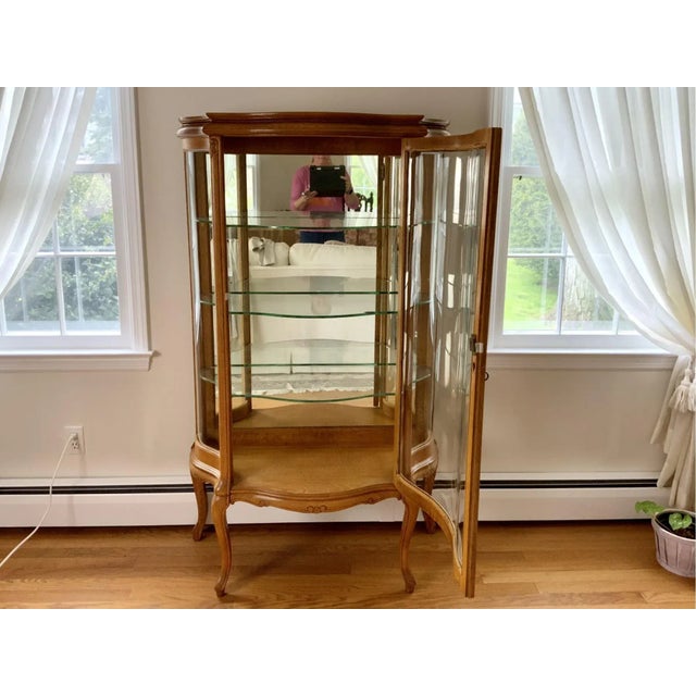 Early 20th century Victorian carved oak bow-front lighted curio china cabinet with three glass shelves and brass keyhole...