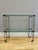 A brass and glass two tier console or etagere by Peter Ghyczy. Typical thick glass plates. Stamped on each brass...