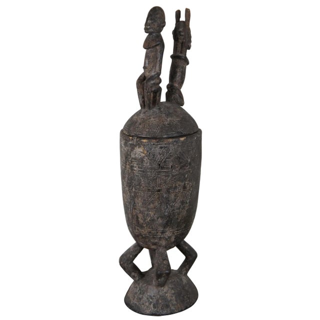 Monumental antique carved wooden Dogon ceremonial vessel consisting of an urn shaped body supported on a four legged base,...