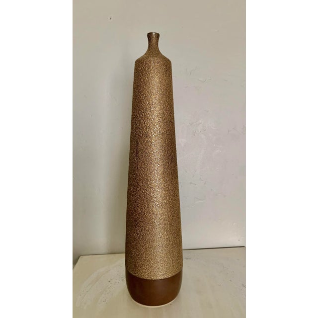 Standing rare 27” high, this stunning Mid Century Modern style antique gold finish textured ceramic vase is a showstopper!...